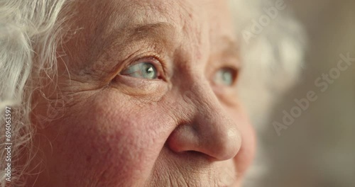 Thinking, eyes and senior woman closeup in a nursing home with memory, nostalgia or moment of reflection closeup. Remember, face and zoom on elderly female person waiting in a retirement facility photo