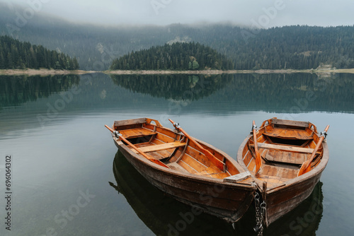 Fototapeta Naklejka Na Ścianę i Meble -  Two Rowboats on Morning Mountain Lake with Mist