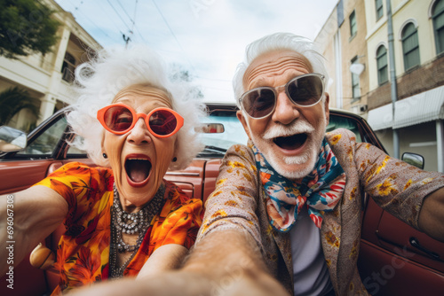 Couple of trendy elderly people taking a selfie, Spirited portrait, happy smiling group of senior citizens, pensioners having fun