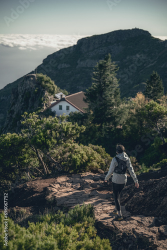 Solitary Hiker Approaching Mountain Refuge in Madeira