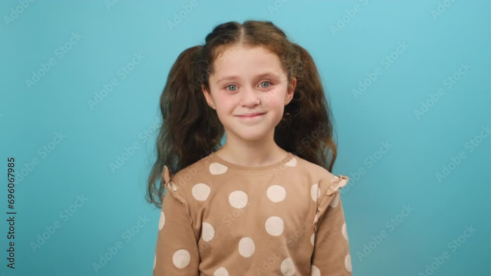 Come to me, I want to embrace you. Pleasant expression, love feelings. Portrait preteen girl you come to me, come here, calling beckoning, coming closer, isolated on blue background wall in studio