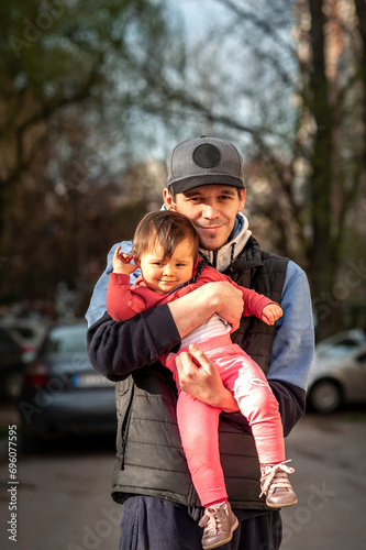 Dad embraces his young daughter in a hug.
