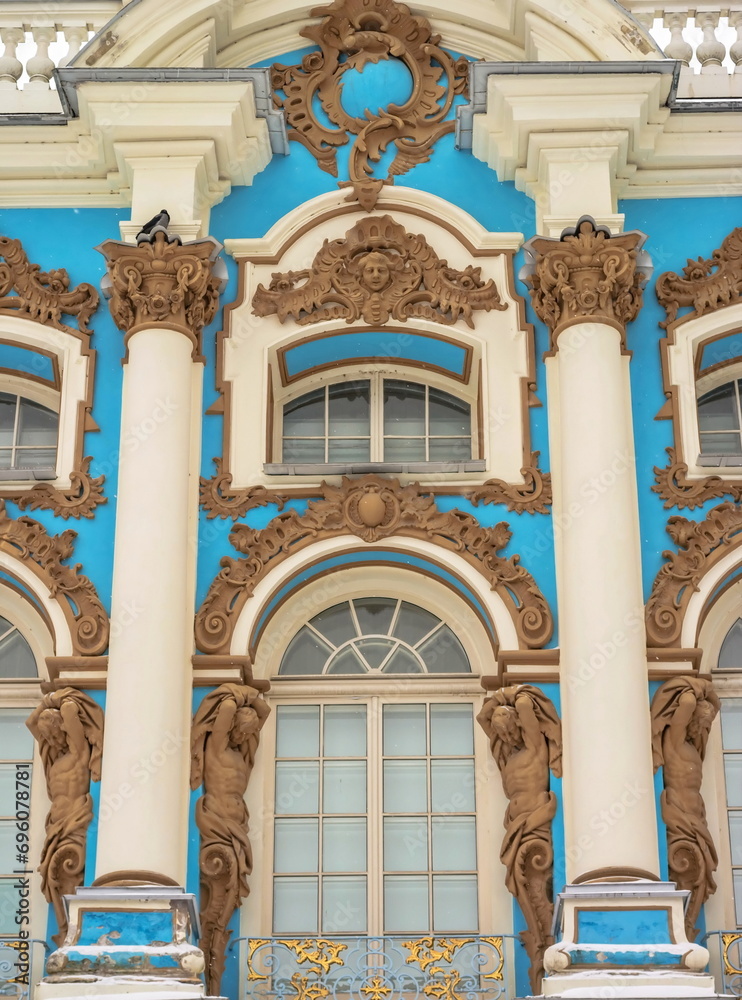 The facade of the old Baroque building is decorated with stucco and statues of Atlanteans