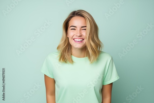 Laughing Woman in Light Green T-shirt on Pastel Mint Background. Generative AI.