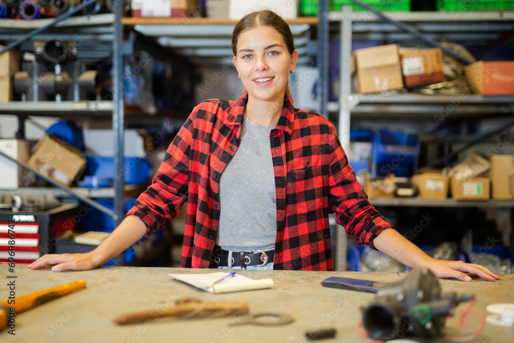 Fototapeta premium Portrait of an positive female worker in large store warehouse