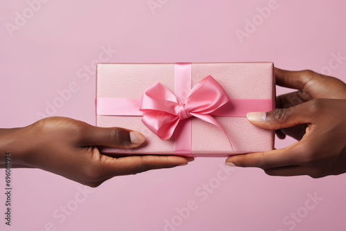 Hands with gift box for birthday, Valentine's Day, Christmas, or Mother's Day © Fox Bread
