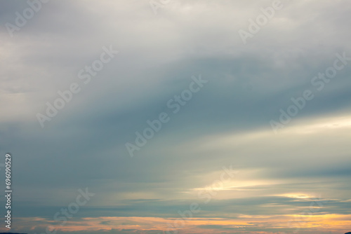 Romantic sky in pastel nude colors with hazy clouds and sunbeam on the horizon surrounded by cinematic environment