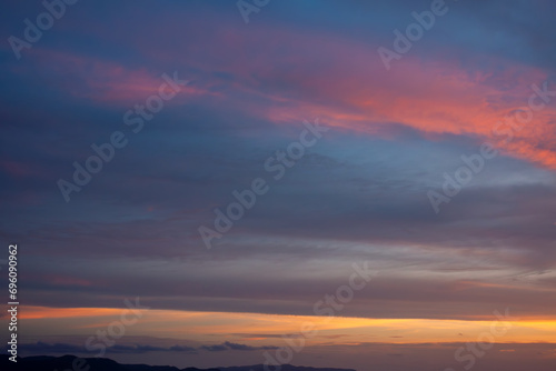 Amazing natural fenmen on the romantic colorful sunset sky with illuminated contrast warm clouds on the horizon surrounded by cinematic atmosphere © ABContent Creator
