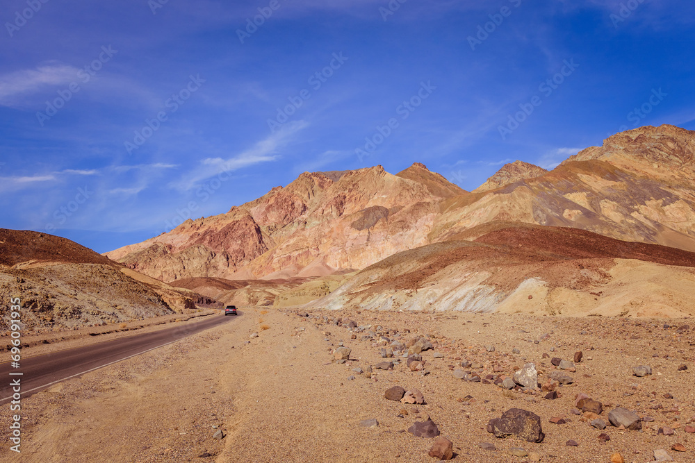 Lonely car on the road in Death Valley mountains