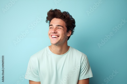Caucasian Male Model Laughing. Isolated on a plain light blue background. Generative AI.