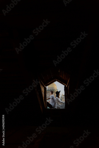 A man and woman hugging and kissing on a roof. Rooftop in Saint-Petersburg.