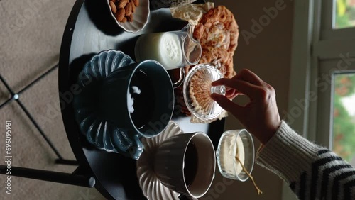 Aesthetic breakfast. Milk coffee, milk tea, sugar, almond, almond cakes, biscuits, marzipans and puffs. British breakfast in a cozy home. Autumn mood. Vertical video.