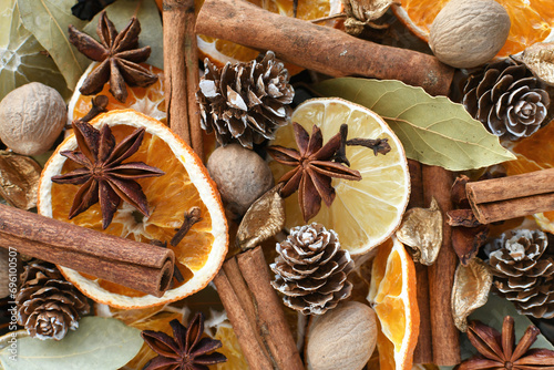 Winter holiday potpourri - mix of dried oranges, cinnamon stick, nutmeg, star anise, cloves, pine cones, bay leaves for a festive blend of scents photo