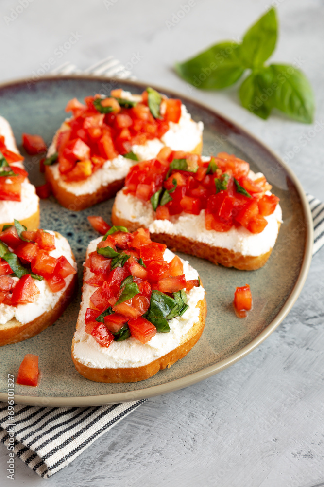 Homemade Tomato Ricotta Tartine on a Plate, side view.
