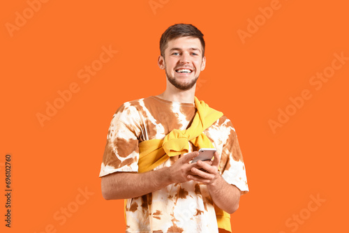 Young bearded man with mobi...