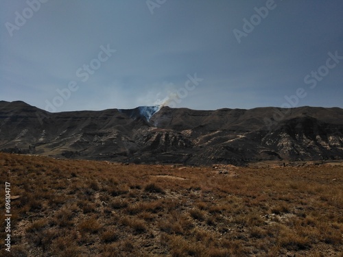 Smoking rising from a mountain after a wildfire, Lesotho photo