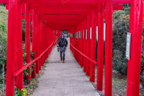 Walking Through the Torri Gates at Motonosumi Shrine, Nagato, Yamaguchi, Japan photo