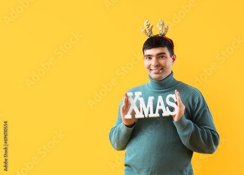 Young man in deer horns wit...