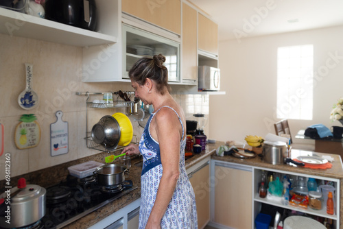 A woman in the kitchen making food.