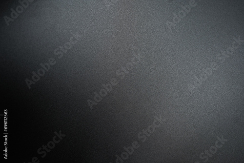 Black paper background with light for adding letters.