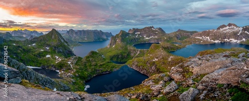 Panorama, view over mountain peaks and sea, with lakes Litlforsvatnet, Tennesvatnet, Krokvatnet and fjord Forsfjorden, dramatic sunset, from Hermannsdalstinden, Moskenesoey, Lofoten, Nordland photo