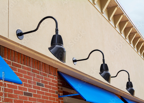 Fotografija Gooseneck lights on storefront wall, Brookline, MA, USA
