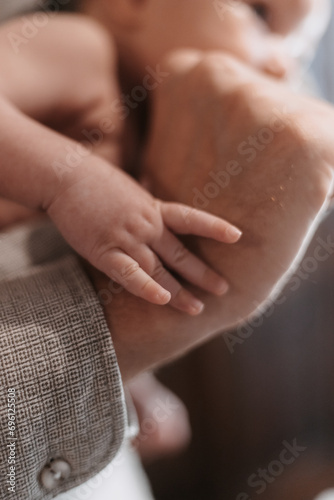 child's hand holding parent