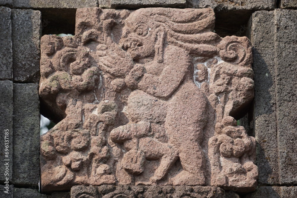 Naked relief on penataran temple wall in Indonesia