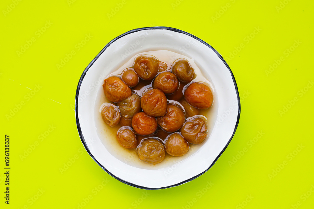 Pickled plums on green background. Pickled plums on green background.