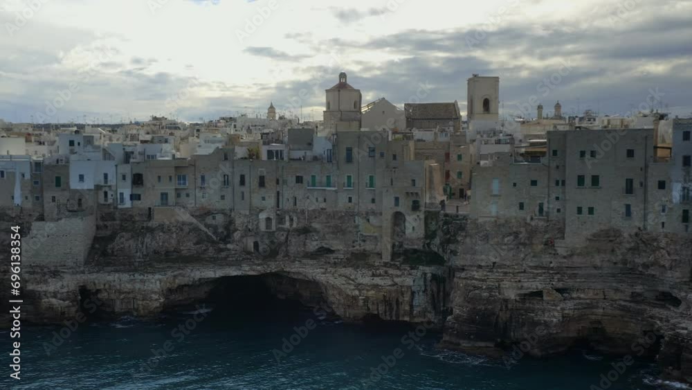 Drone aerial view of Polignano a Mare iconic white traditional city in the sea cliffs of the south of Italy in the region of Puglia Drone aerial view of Polignano a Mare iconic white traditional city in the sea cliffs of the south of Italy in the region of Puglia