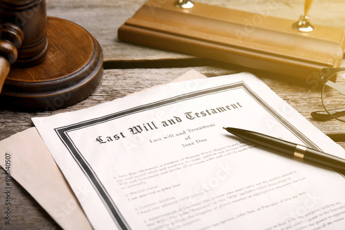 Last Will and Testament, pen and gavel on wooden table, closeup