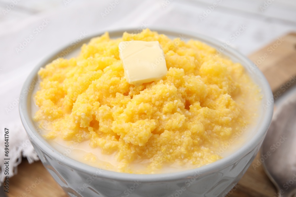 Tasty cornmeal with butter in bowl on table, closeup Tasty cornmeal with butter in bowl on table, closeup