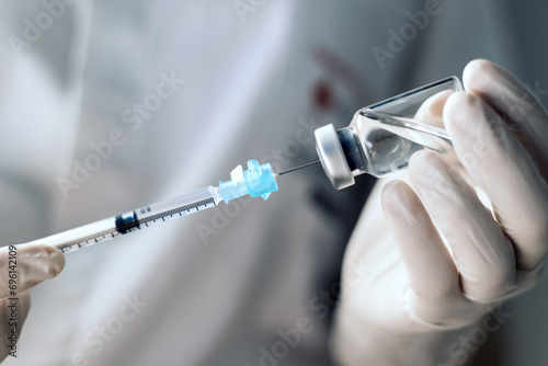injecting injection vaccine vaccination medicine covid into a syringe woman nurse. Close-up photo