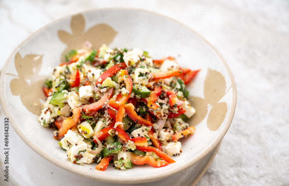 Close up of Feta, Cucumber and Red peppers Salad in Handmade Ceramic Bowl Close up of Feta, Cucumber and Red peppers Salad in Handmade Ceramic Bowl