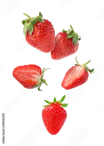 Fresh ripe strawberries falling on white background