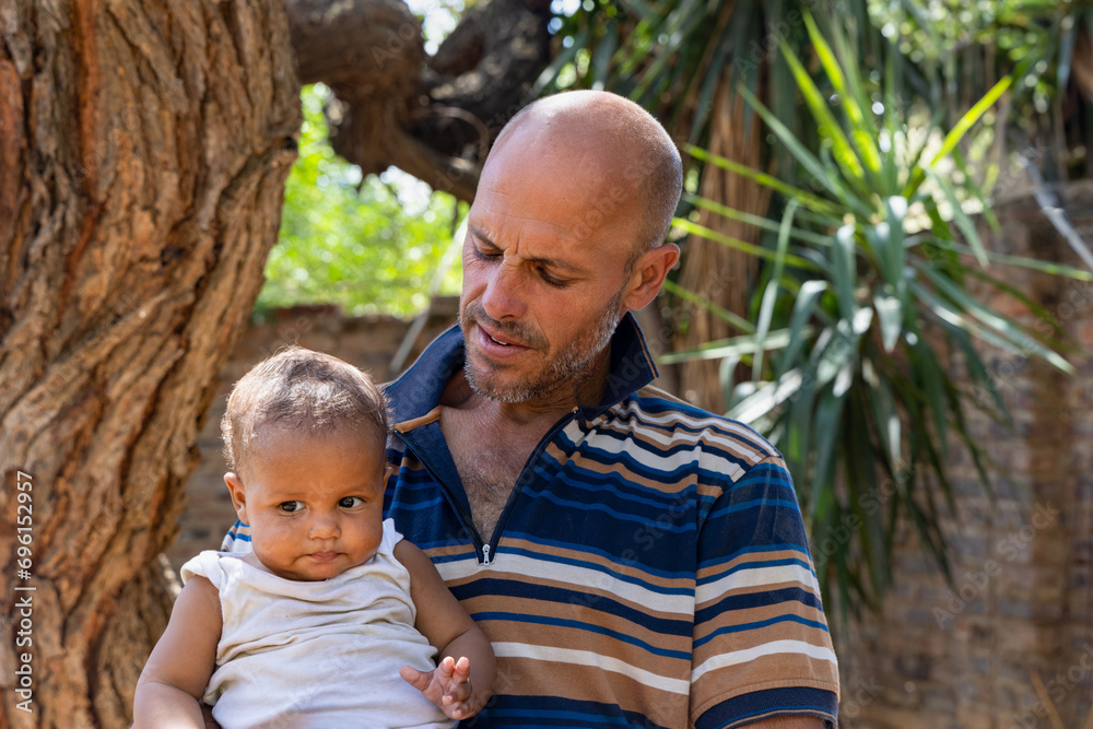 portrait of father and mixed race son standing in the yard portrait of father and mixed race son standing in the yard