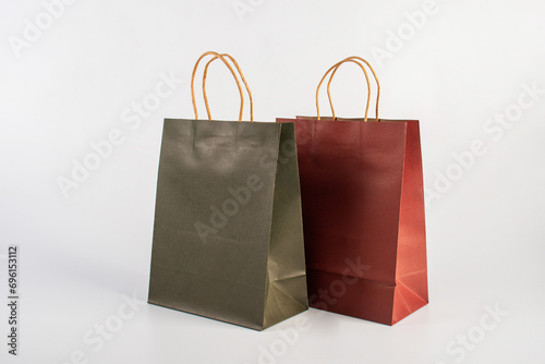 Red and green paper shopping bag on white background.