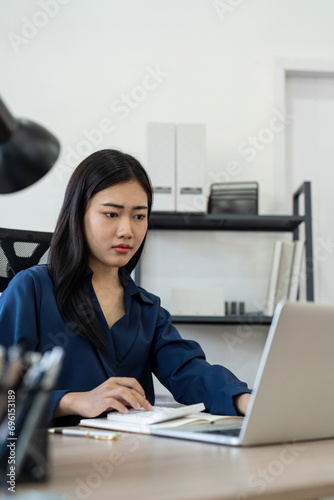 Professional businesswoman working at her home via laptop, young female manager using computer laptop while sitting on desk, work process concept