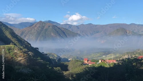 Morning fog at sunrise in mountains of Bosque Nativo, Loja, Ecuador photo