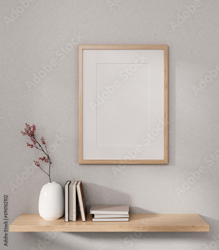 Fototapeta Naklejka Na Ścianę i Meble -  Front view of a picture frame mockup and a wooden wall shelf with home decor on a white wall.