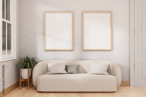 A cosy modern, Scandinavian living room with a white couch, picture frames mockup on a white wall.