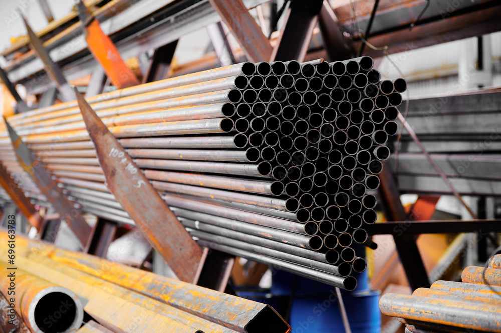 Set of cold rolled pipes on metal shelving unit in storage Set of cold rolled pipes on metal shelving unit in storage