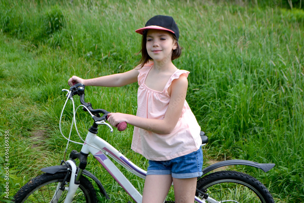 Young girl cyclist enjoy the beautiful sunrise on summer forest trail Young girl cyclist enjoy the beautiful sunrise on summer forest trail