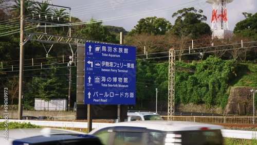 Cars Passing Road Sign in Toba City, Mie Prefecture Japan. Establishing Shot photo
