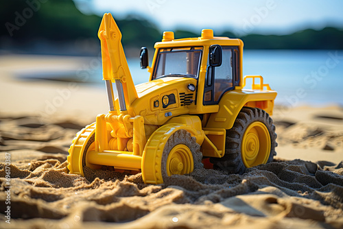 Backhoe toy yellow plastic on beach sand
