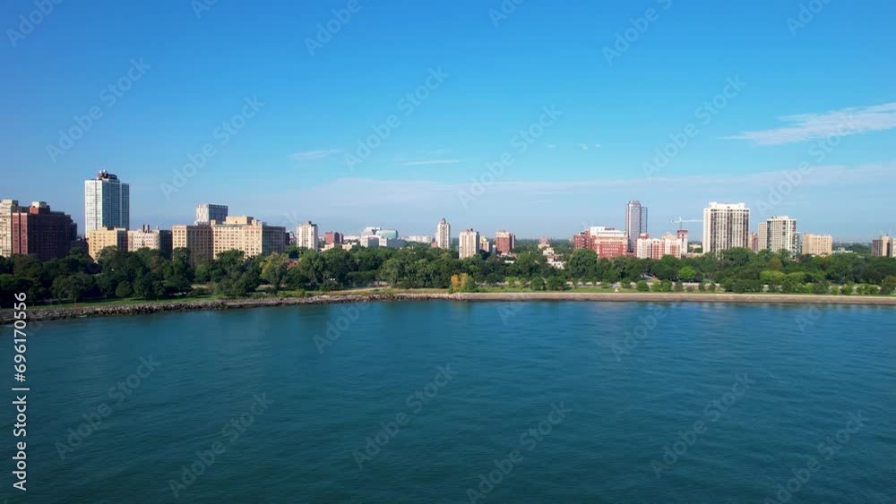 Waterfront Park With Lush Green Trees Blue Water And Apartment Buildings Waterfront Park With Lush Green Trees Blue Water And Apartment Buildings