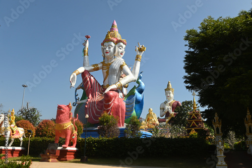 A large outdoor four-faced and four-hands Brahma statue represents the multicultural beliefs of Buddhists located at Wat Saeng Kaew Phothiyan temple. At Chiang Rai Province in Thailand. photo