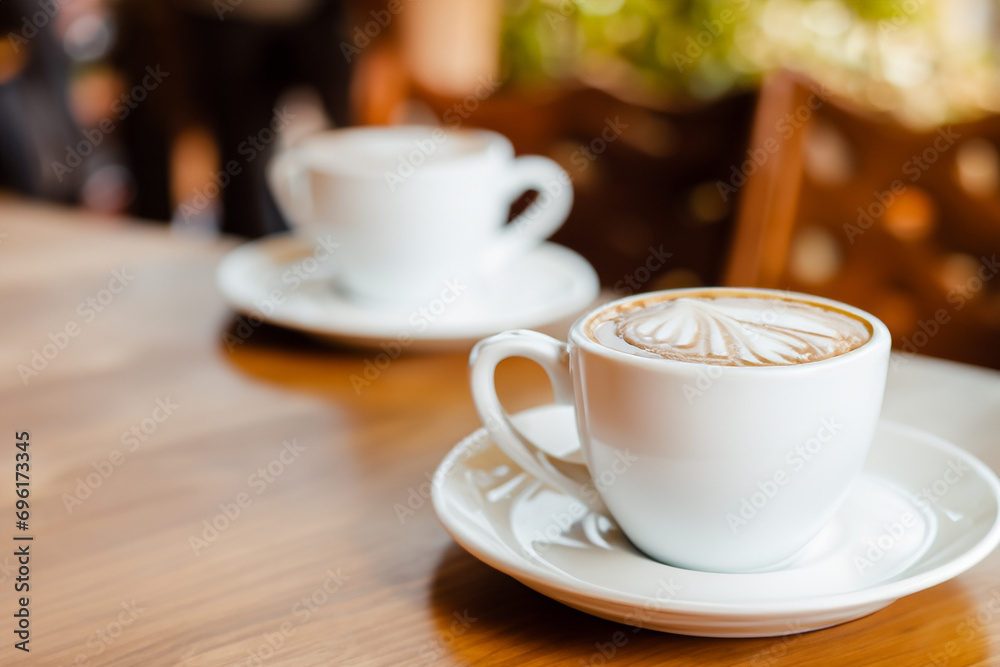 Coffee cup on the table on a blurred background, latte art Coffee cup on the table on a blurred background, latte art