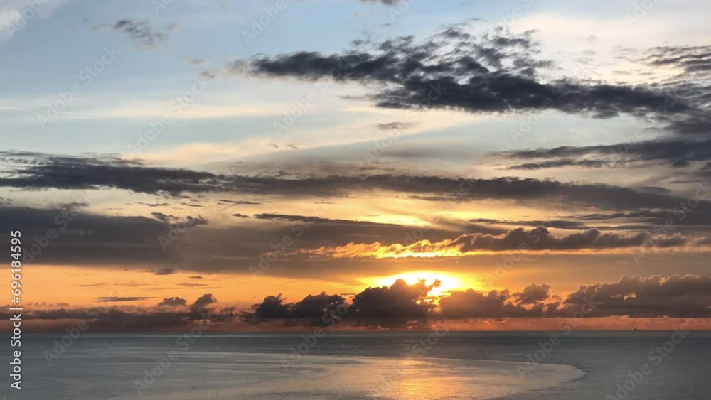 Timelapse of the rays of the setting sun breaking through the layered clouds over the Pacific Ocean Timelapse of the rays of the setting sun breaking through the layered clouds over the Pacific Ocean
