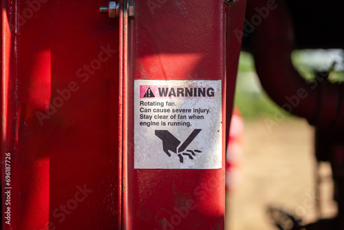 The caution sign to inform pinch point and hand injury hazard which is displayed on the machinery equipment part. Industrial safety symbol object, close-up photo